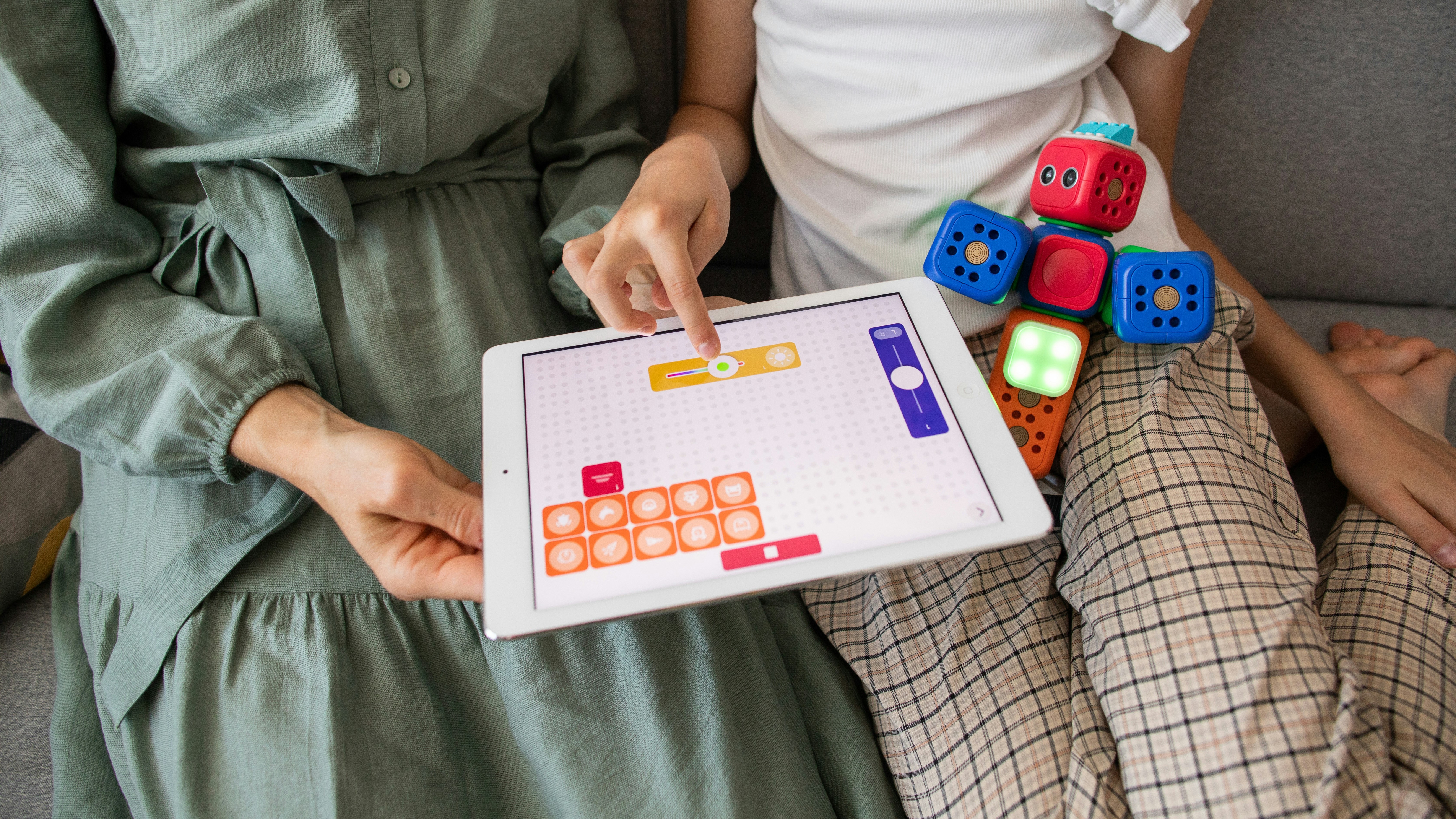 Child and caregiver exploring a therapy tablet activity